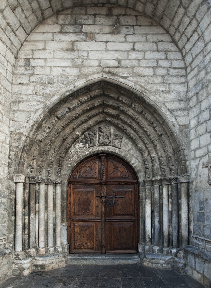 Brown Wooden Door on Gray Concrete Building