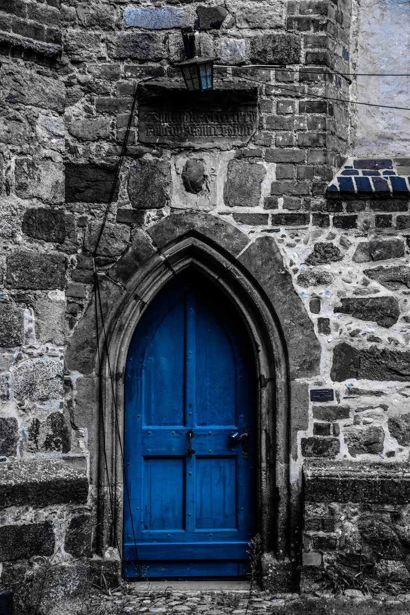 Brown Wooden Door on Gray Brick Wall